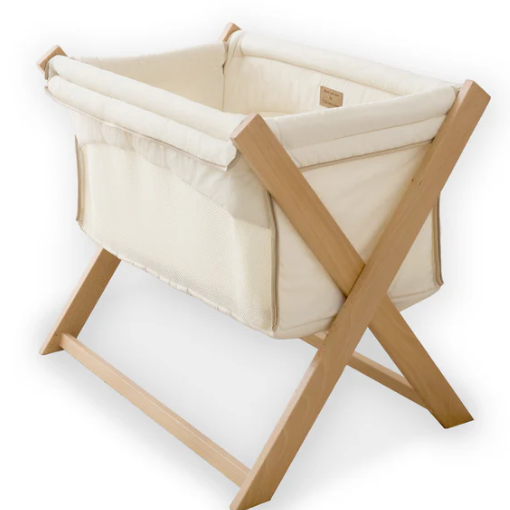 Clair De Lune Organic Folding Crib in cream color with a bamboo mattress, foldable design, and mesh side panels.